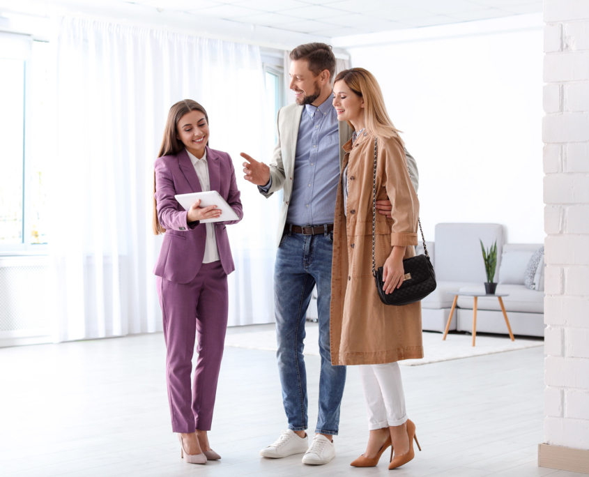 real estate agent working with couple in room