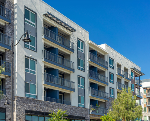 New modern apartment building with balconies and blue sky