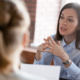 Confident focused businesswoman, teacher or mentor coach speaking