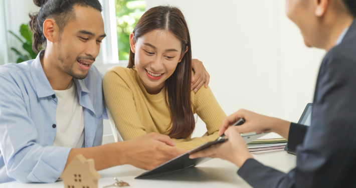 Realtor agent giving a key of apartment to new owner after signed lease agreement