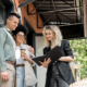 smiling real estate agent showing documents to interracial couple